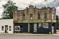 Front of an aged and worn exterior of abandoned store selling toys, souvenirs, gifts, and drugs Royalty Free Stock Photo