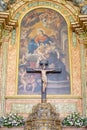 in front of the altar with a figure of Jesus Christ in the center inside the Igreja Matriz de Colares Nossa Senhora da AssunÃ§Ã£o