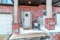 Front of apartment building with white front door and red brick exterior wall Royalty Free Stock Photo