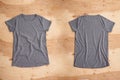 Front and back of dark grey melange empty T-shirt on wooden background