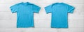 Front and back views on boys t-shirts on white wooden desk background. Mockup for design closeup Royalty Free Stock Photo