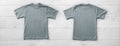 Front and back views on boys t-shirts on white wooden desk background. Mockup for design closeup Royalty Free Stock Photo