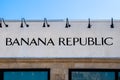 Front of Banana Republic Store with liights above signon rough stucco surface and strip of blue sky in Utica Royalty Free Stock Photo