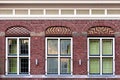 Front beautiful old flat house facade pattern from red brick wit Royalty Free Stock Photo