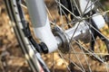 Front bicycle hub with a visible caliper, spokes and a brake disc. Royalty Free Stock Photo