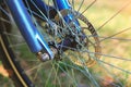 Front Bicycle wheel on green grass background close-up Royalty Free Stock Photo