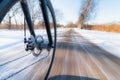 Front bicycle wheel spinning motion blur. Bicycling on slippery snow Royalty Free Stock Photo