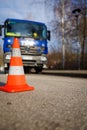 in front of the blue vehicle of the technical relief organization THW is an orange pylon