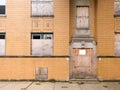 Front of boarded apartment building.