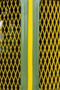 Front, bonnet, grille of a vintage tractor in green with yellow central stripe and yellow diamond-shaped air intake grille and Royalty Free Stock Photo