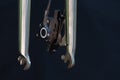 The front brake and the iron chrome-plated rigid bicycle fork are close-up on a black background. Professional bicycle workshop Royalty Free Stock Photo