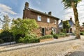 the front of a brick house with a gravel driveway Royalty Free Stock Photo