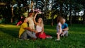 In front of the camera a cute small girl with a big pink airplane playing with her parents and grandfather in the park Royalty Free Stock Photo