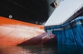 Front cargo ship moored in floating dry dock yard under repair in shipyard Royalty Free Stock Photo