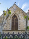 Front of the church building, white cross over window arch Royalty Free Stock Photo