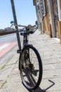 front of city bike which is secured to the sign on the street