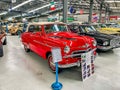 Front closeup of a red Vauxhall Vagabond on display with other cars at the National transport museum