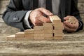 Front closeup view of businessman constructing steps of wooden p