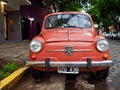 Front closeup view of a vintage Fiat 500 car, parked in the streets of Buenos Aires, Argentina