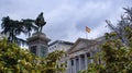 The front of the Congreso de los Diputados building and statue of Miguel de Cervantes