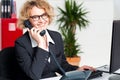 Front desk lady attending clients call Royalty Free Stock Photo