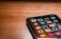 Front display of a black iPhone XR on a wooden table