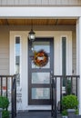 Front door of beautiful house with colorful flower wreath. Decoration on the wooden door Royalty Free Stock Photo