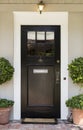 Front door with black exterior Royalty Free Stock Photo