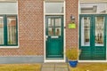 the front door of a brick house with green doors Royalty Free Stock Photo