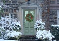 Front door with Christmas wreath with red holly berries Royalty Free Stock Photo