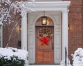 Front door with Christmas wreath on woodgrain door Royalty Free Stock Photo