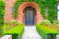 Front door of an English cottage decorated with garden plants and flowers Royalty Free Stock Photo
