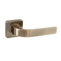 Front door handle in high-gloss bronze color on a square base in a modern classic shape Royalty Free Stock Photo