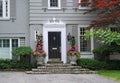 Front door of house with potted flowers Royalty Free Stock Photo