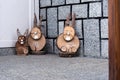 At the front door of the house there are three wooden rabbits