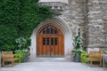 Front door with leaded glass and ivy covered stone wall of gothic style college building Royalty Free Stock Photo
