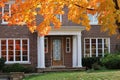 front door with maple tree in brilliant fall color Royalty Free Stock Photo