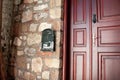 Front Door And Metal Mailbox of a Old Stone House. Red Street Door Close Up. Royalty Free Stock Photo