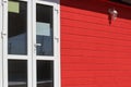 Front door of an office or house of the facade is made of wood painted red Royalty Free Stock Photo