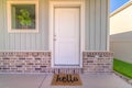 Front door and porch of home with hello mat Royalty Free Stock Photo