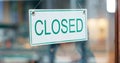 Front door, small business or closed sign on window in coffee shop or restaurant for end of service. Closing time, diner