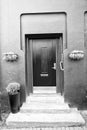 Front door with steps in reykjavik, iceland. House entrance with red door and pot plant decoration. Private property and