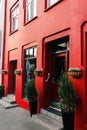 Front door with steps in reykjavik, iceland. House entrance with red door and pot plant decoration. Private property and real