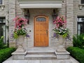 Front door of stone house with large flower pots