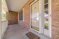 Front door of suburban brick home with welcome mat Royalty Free Stock Photo