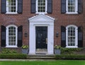 Front door of traditional two story brick house Royalty Free Stock Photo