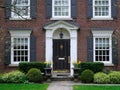 Front door of traditional two story brick house Royalty Free Stock Photo