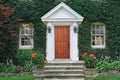Front door of vine covered house