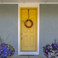 Front door with wreath and colorful potted flowers Royalty Free Stock Photo