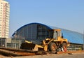 Front-end loader working on construction site during the renovation of the road.